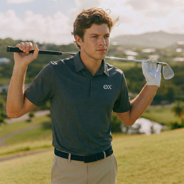 Man wearing a Black polo with premium embroidered logo detail.