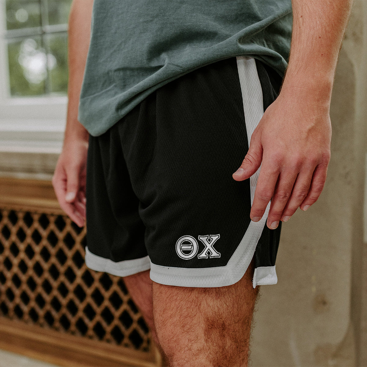 Theta Chi Greek Fraternity Black 7" Mesh Shorts with Greek letters.
