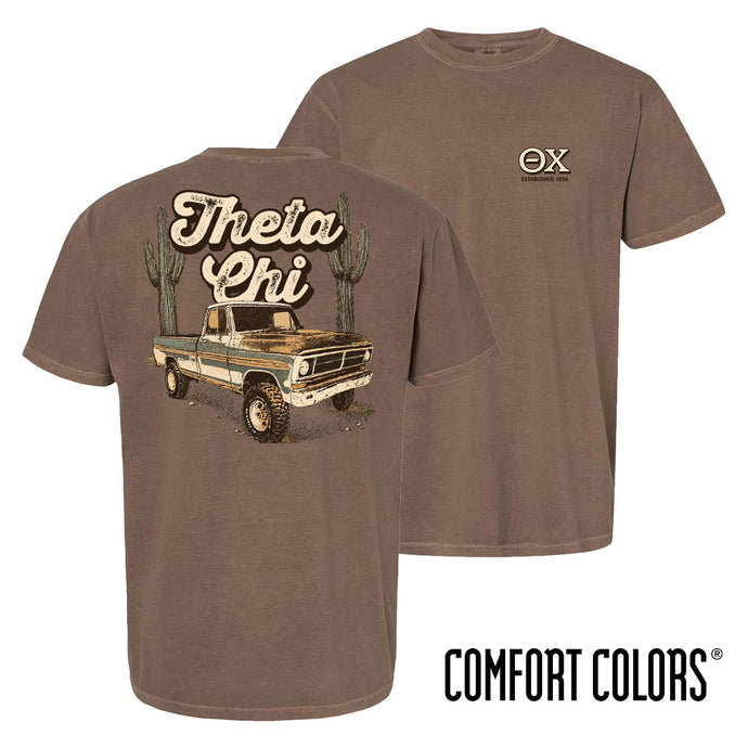Comfort Colors Desert Highboy Tee shown front and back, featuring a small Theta Chi chest graphic and a large vintage truck desert design on the back.