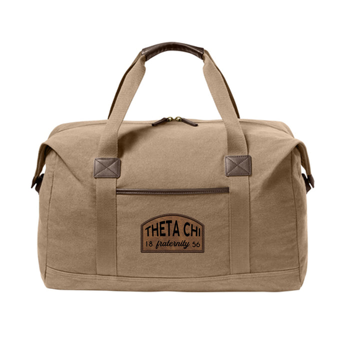 Fraternity Tan Canvas Duffel Bag with leather patch on front.