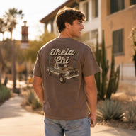 Model wearing the Desert Highboy Tee from the back, showing the Theta Chi vintage truck and cactus graphic in an outdoor campus setting.