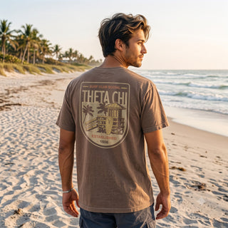 Brown Comfort Colors Surf Club Social T-shirt featuring a small front logo and a large surf club back graphic.