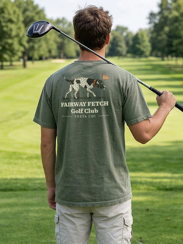 Man wearing a moss green Comfort Colors T-shirt with golf-themed graphic on the back.