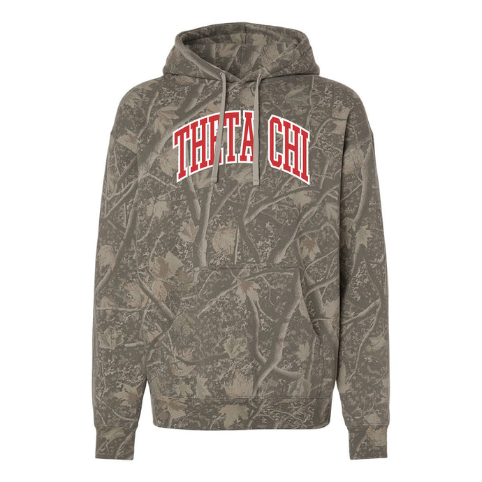 Theta Chi Deadwood Camo Hoodie featuring an all-over woodland camouflage print, red and white arched Theta Chi lettering, drawstring hood, and kangaroo pocket.
