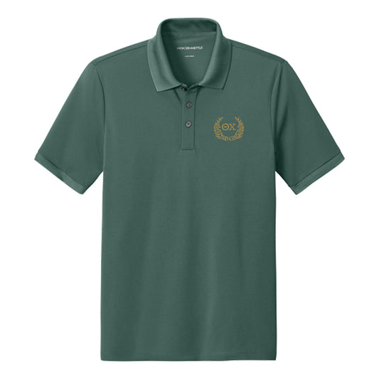 Front view of Green polo featuring embroidered laurel design.