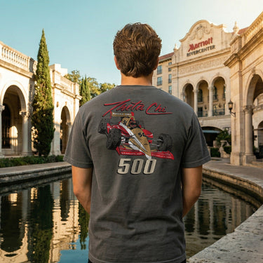 Back view of a model wearing the gray Theta Chi Indy 500 tee outdoors, showcasing the full retro racing graphic design.