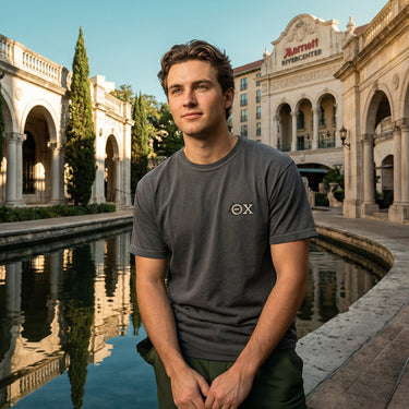 Front view of a model wearing the gray Theta Chi Indy 500 tee with a classic Theta Chi chest emblem.